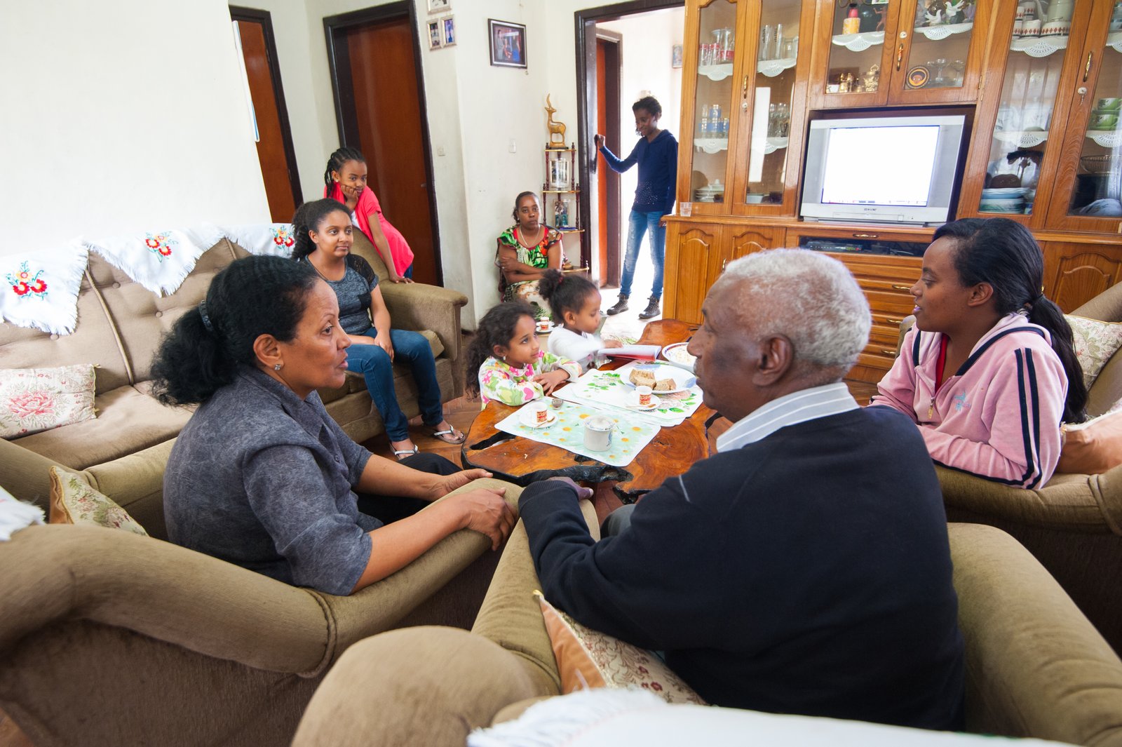 Family gathering in a living room, Addis Ababa, Ethiopia.