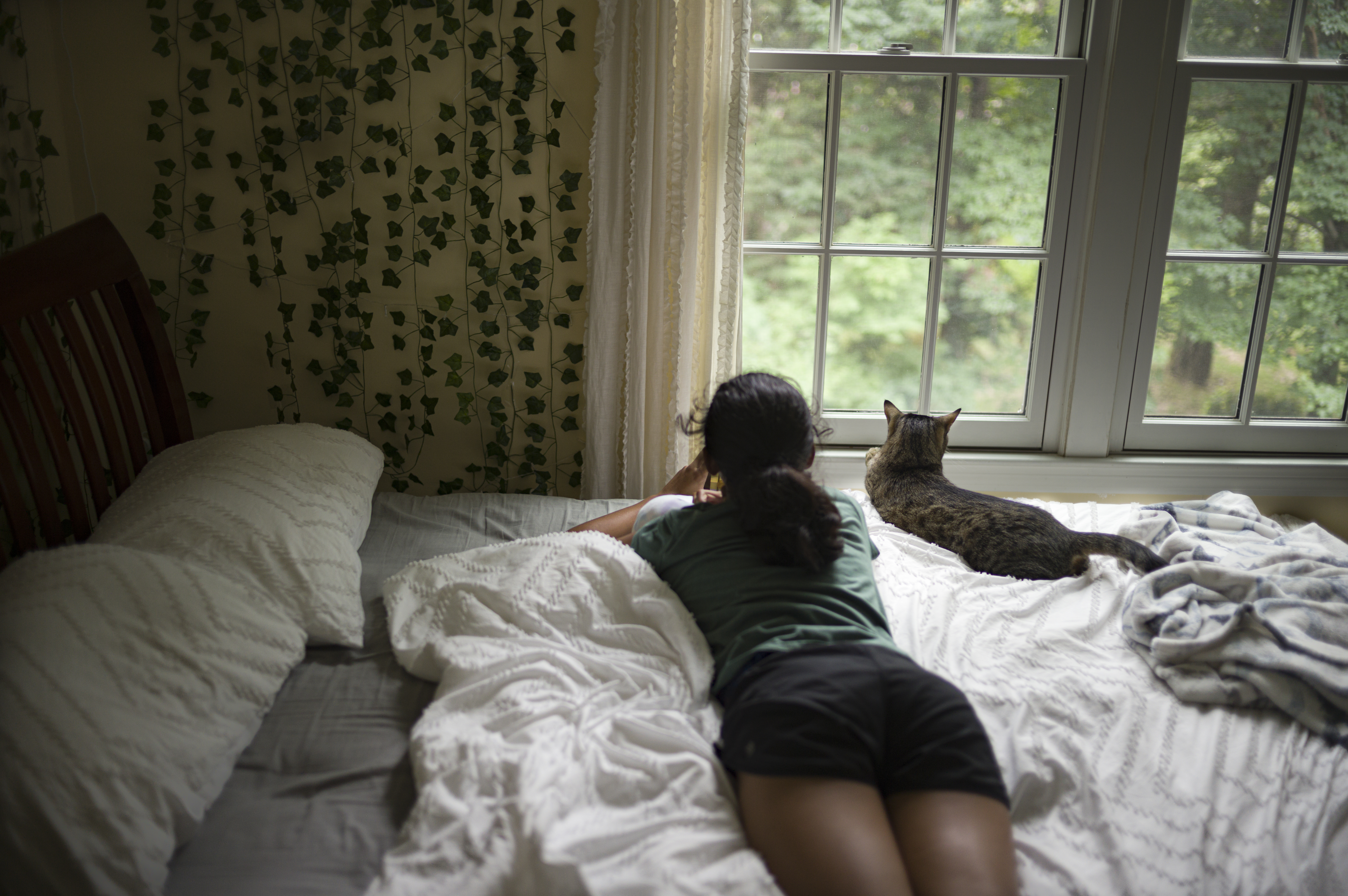 Kriti on bed with cat Mick, Boston, 2023